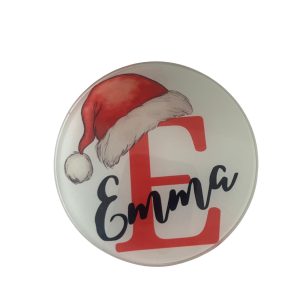 Close-up of clear glass coaster with personalised initial and name design.